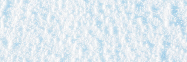 Natural snow texture. The surface of an icy snow crust. Snowy ground. Winter background with snow patterns. Closeup top view. Wide panoramic texture for background and design.
