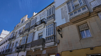 White buildings with balconies and bay windows in Cadiz, Spain
