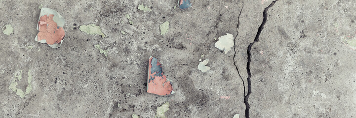 Peeling paint on the wall. Panorama of a concrete wall with old cracked flaking paint. Weathered...
