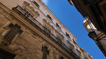 Fototapeta premium Ornate balconies and cross shaped window decorating building in Cadiz, Spain