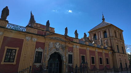 Palace of San Telmo exhibiting sculptures on the rooftop in Seville