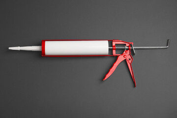 One glue gun on gray background, top view