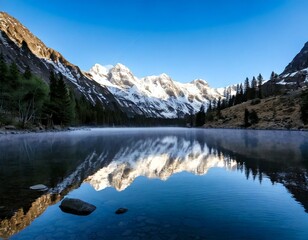 lake reflecting jagged snow-covered peaks with drifting 