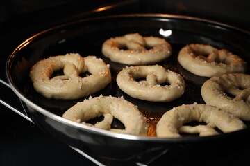 Baking dish with pretzels in oven, closeup