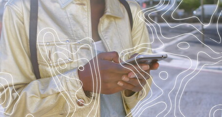 Image of moving shapes over woman using smartphone