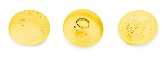 Drops of golden serum on white background, set