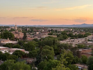 Fototapeta premium Santa Fe, New Mexico, USA - watching sunset over Santa Fe New Mexico, beautiful red sunset with wildfire at the background, romantic view of Santa Fe downtown, galleries and museums