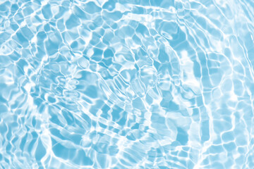 Blue water with ripples on the surface. Defocus blurred transparent blue colored clear calm water surface texture with splashes and bubbles. Water waves with shining pattern texture background.
