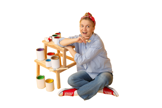 Woman sitting on the floor with paint cans, isolated on white, PNG