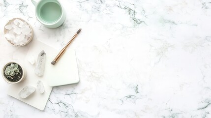 Calm workspace arrangement on marble featuring crystals, succulents, and writing supplies.