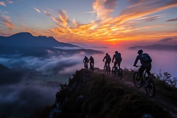 Fototapeta premium Group of mountain bikers riding along ridge silhouetted by a bold sunrise sky with streaks of gold and pink Misty valleys below Dynamic adventurous and scenic