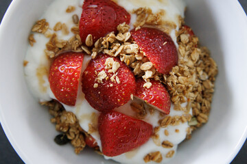 breakfast with granola, strawberries, greek yogurt and honey