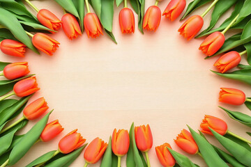 bunch of orange tulips on a wooden table