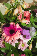 Heart sunglasses placed on pink and purple spring flowers