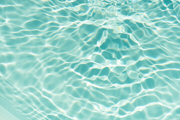 Obraz premium Blue water with ripples on the surface. Defocus blurred transparent blue colored clear calm water surface texture with splashes and bubbles. Water waves with shining pattern texture background.