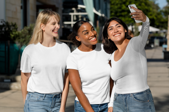 Casual apparel mockup png, transparent tshirts, mixed race girlfriends taking a selfie