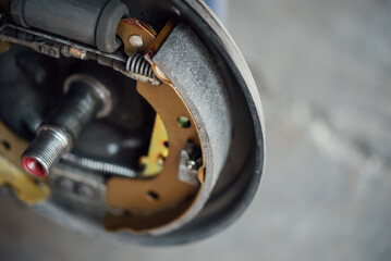 Drum brake and asbestos brake pads at car garage
