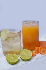 lemon, carrot, juice in glass isolated on white background. Healthy food and drink natural nutrition diet concept.