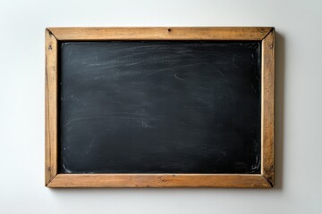 A rectangular chalkboard with a wooden frame hanging on a light wall space