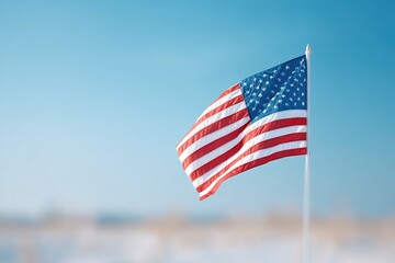 Obraz premium flag flutters at half-staff against blue sky in field of white tombstones on memorial day with ample copy space for