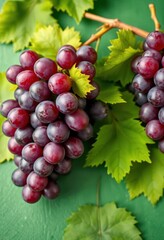 Fototapeta premium Luscious purple grapes with vibrant green leaves, artfully arranged on a green background, juicy, refreshment, color