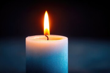 close-up of solitary candle flame gently flickering against soft dark background symbolizing hope and awareness on