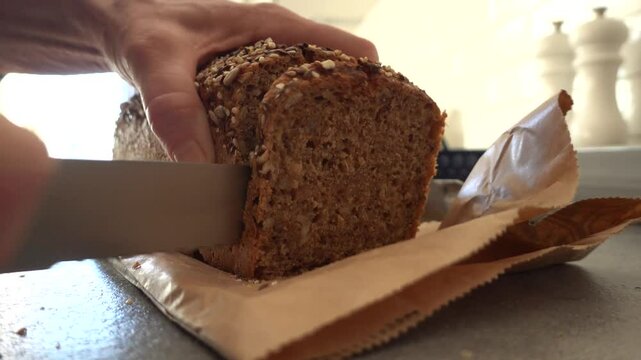Stockholm, Sweden A cook slices Danish dark bread on a countertop. 