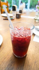 A glass of red berry juice that looks refreshing and delicious