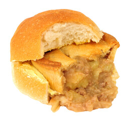 Wigan kebab meat and potato pie sandwich a savoury pie in a buttered bread roll popular chip shop food item from Wigan Greater Manchester England isolated on a white background