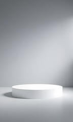 Fototapeta premium A round white pedestal stands on a grey surface.