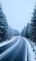 Obraz premium A snowy road in between trees.