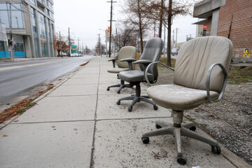 Empty office chairs on sidewalk