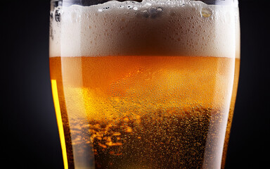 glass of beer on dark background