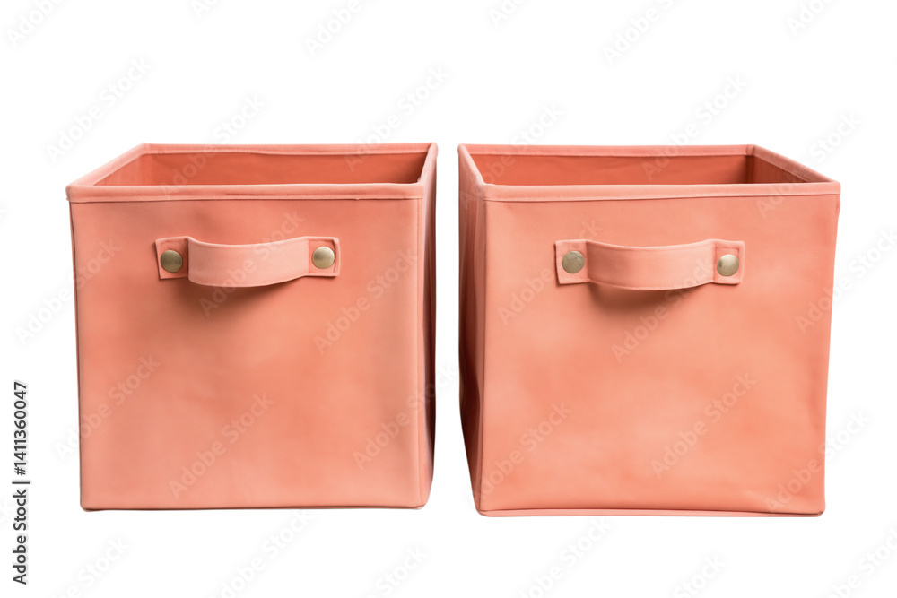 Poster close up of two peach colored storage boxes with handles against a dark background in the studio sho