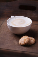 Cappuccino on dark wooden background. Soft focus. Close up.	