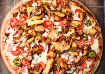 Gyros Pizza with jalapeno pepper, cherry tomatoes and mozzarella cheese. Soft focus. Close up.	