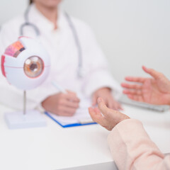 Elderly Patient consulting Doctor to Eye disease, Senior Medical Diagnosis. Anatomy Eye model for...