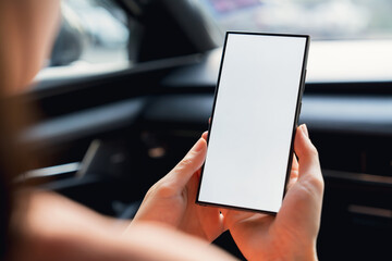 Woman sitting in a private car and hand holding smartphone mockup of blank screen, Take your screen to put on advertising