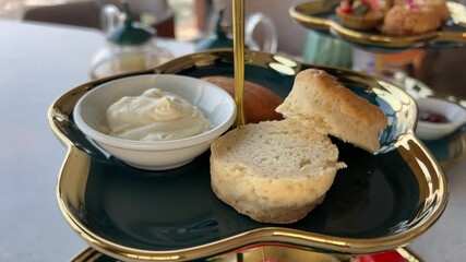 bread mayonnaise plate of scones topped with clotted cream and jam, evoking comfort and indulgence