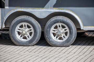 Naklejka premium A fragment of a trailer in the parking lot on a spring day