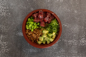 Delicious tuna poke bowl with avocado, edamame, crispy onions and spring onions