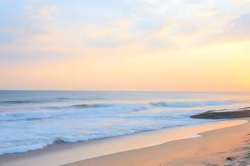 Obraz premium Serene Sunset Beach Scene: Calm Ocean Waves on Sandy Shore