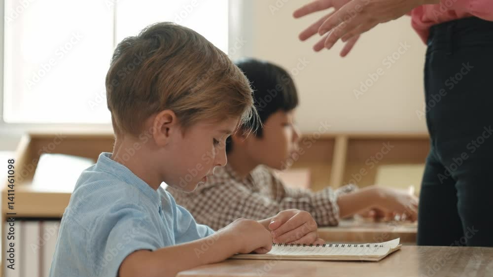 Poster side view of caucasian elementary student looking a note and answer question while sitting in front 