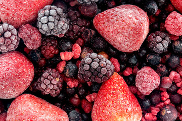 Frozen fruit assortment with strawberries, blackberries, blackcurrant and red current background...