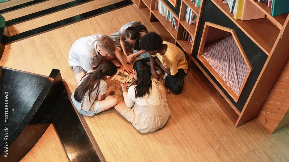 Poster group of diverse children sitting in circle while reading a book at library. top view of girl sharin