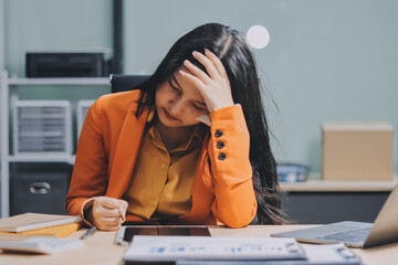 Asian women are stressed while working on laptop, Tired asian businesswoman with headache at...