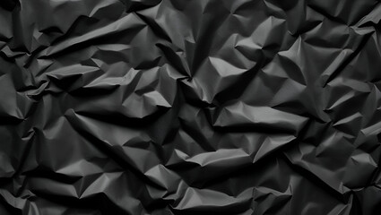Obraz premium Close-up of black crumpled paper texture, dark abstract background or wallpaper, ideal for graphic design or moody themes