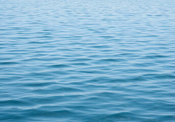Naklejka premium Serene Ocean Water Texture: Gentle Waves, Blue Sea Surface, Calm Water Background