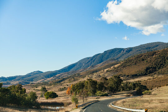 Bendy road through valley with mountains
