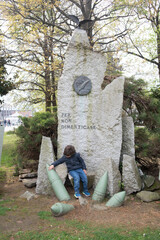 Memorial monument with a child exploring the site